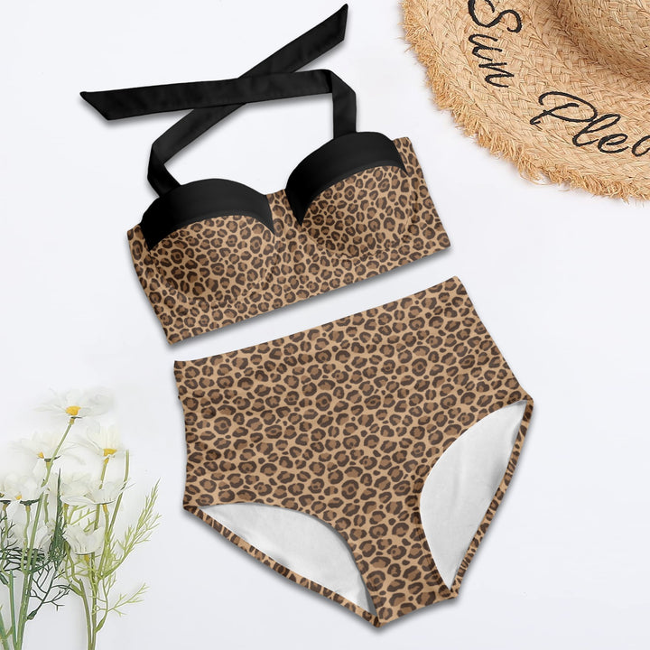 Leopard retro high waist bikini set with black accents, styled with a straw hat and floral accents for a beach look.