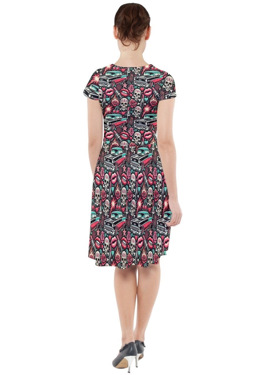 Back view of the Rebel Rose cap sleeve midi dress featuring a vibrant skull and coffin print, perfect for casual outings.