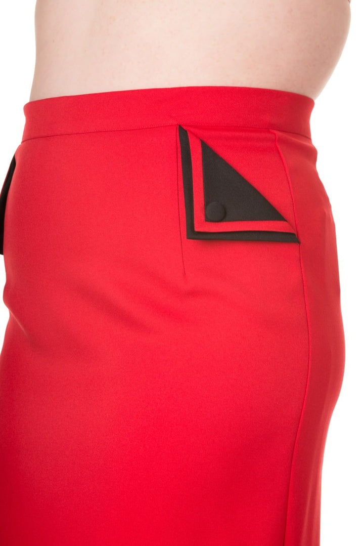 Side view of the Tori Pencil Skirt showing red fabric and stylish side pockets with black button detail.