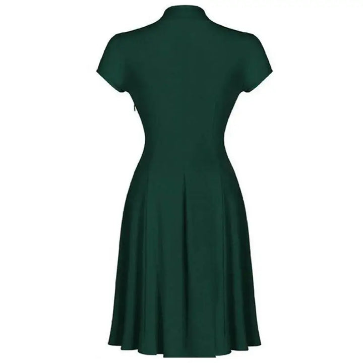 Back view of a dark green vintage-inspired dress with cap sleeves and a flattering knee-length fit.