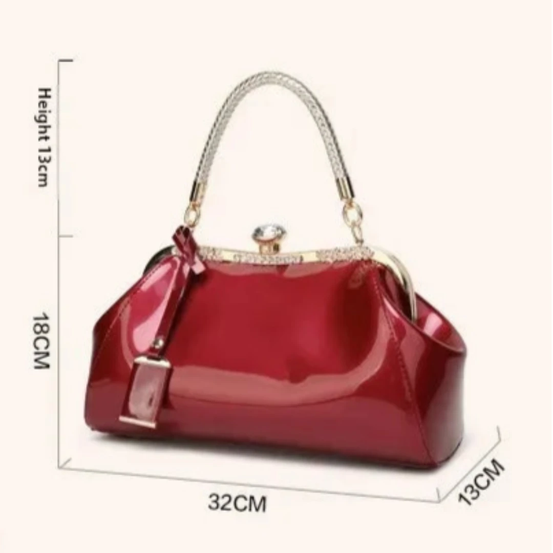 Burgundy patent women's handbag with rhinestone lock, dimensions 32cm x 18cm x 13cm, showcasing stylish design.