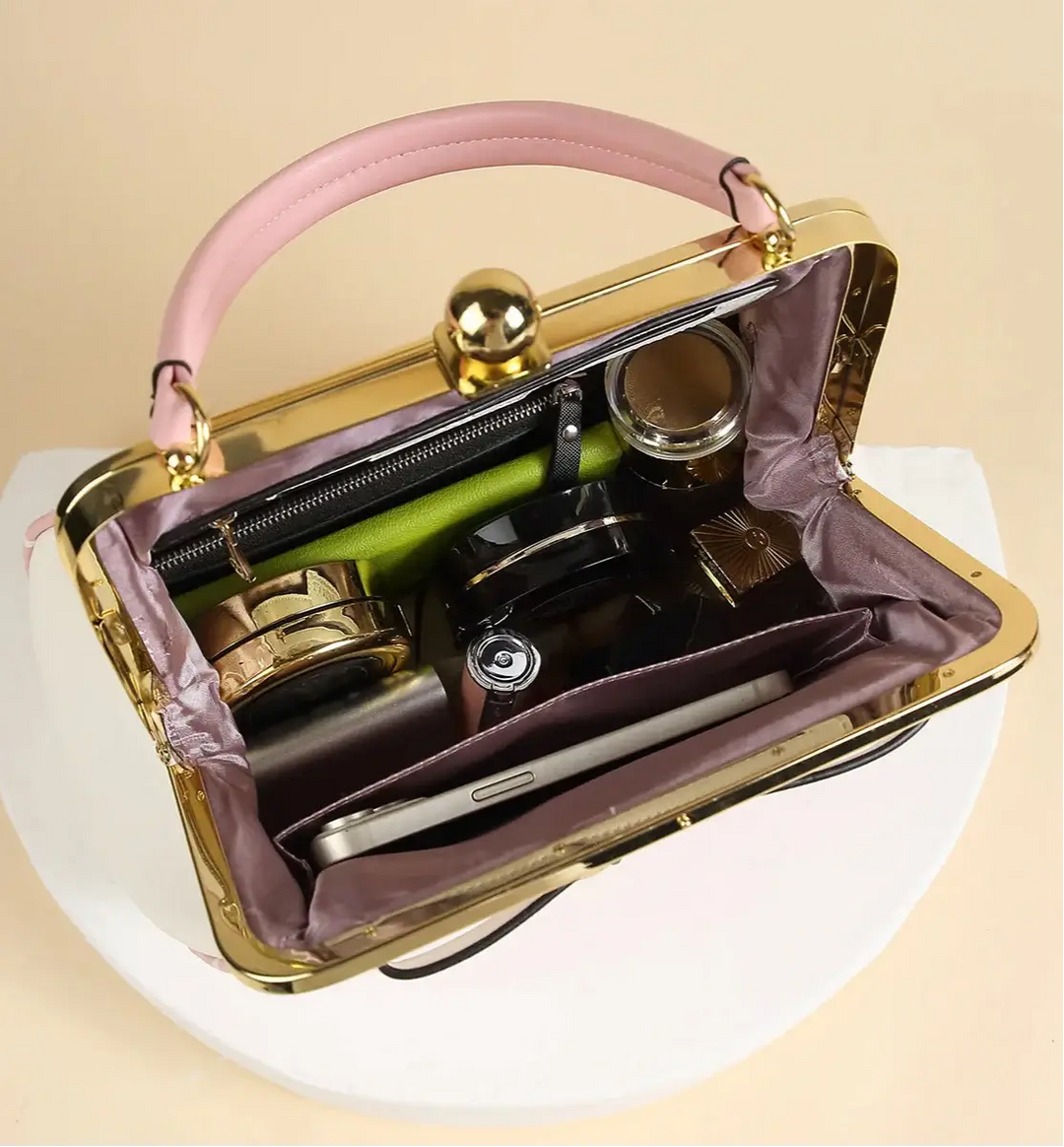 Interior view of the Pink Polka Dot Rockabilly Handbag showcasing elegant storage for cosmetics and a smartphone.