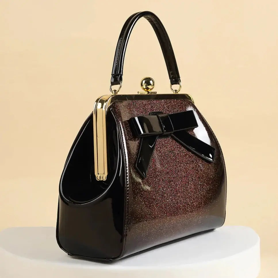 Chocolate Patent Rockabilly Handbag with bow and kiss-lock in shiny vinyl finish, perfect for retro-inspired looks.