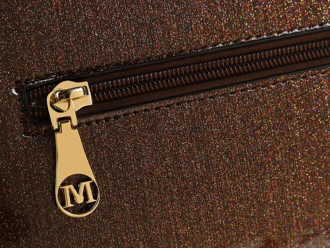 Close-up of a zippered pocket on a chocolate patent handbag, showcasing shiny brown fabric and a gold zipper pull.