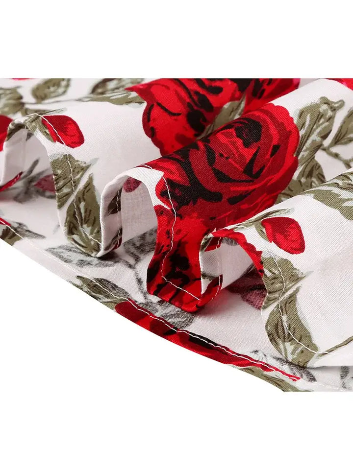 Close-up of the Rose Romance Vintage Swing Dress fabric featuring beautiful red roses on a lightweight cotton blend.