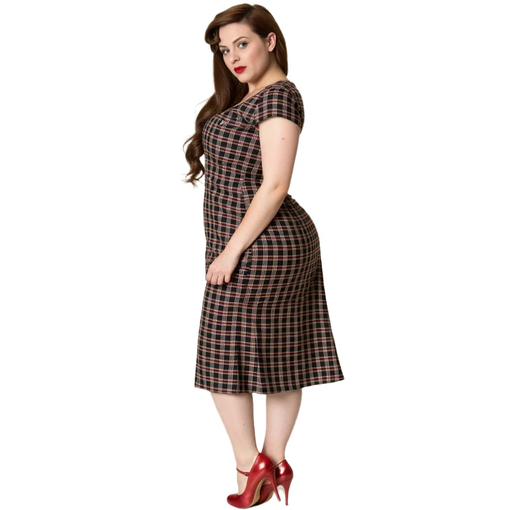 Woman in plaid Elvis Ain't Dead swing dress with cap sleeves and sweetheart neckline, styled with red heels.