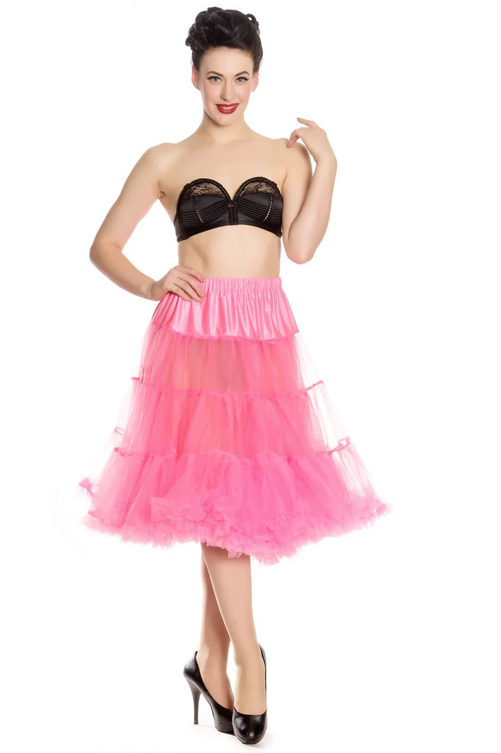 Plus size model in a pink Hell Bunny long petticoat, showcasing retro fashion style with layered tulle design.