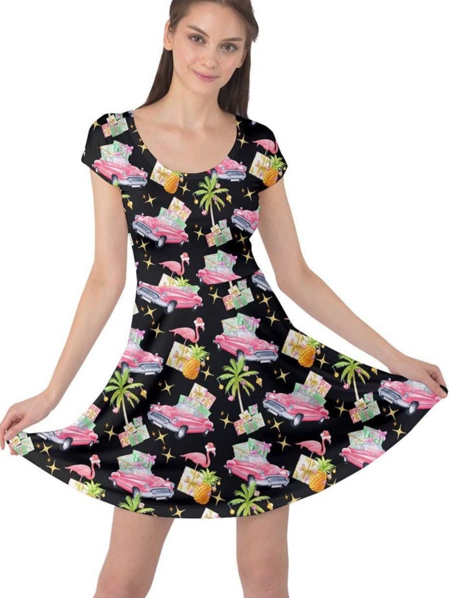 Tropical Christmas cap sleeve dress with flamingos, classic cars, and pineapples in vibrant colors. Perfect for holiday parties.