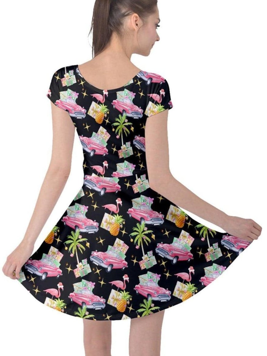 Tropical Christmas cap sleeve dress featuring flamingos, classic cars, and pineapples on a black background.