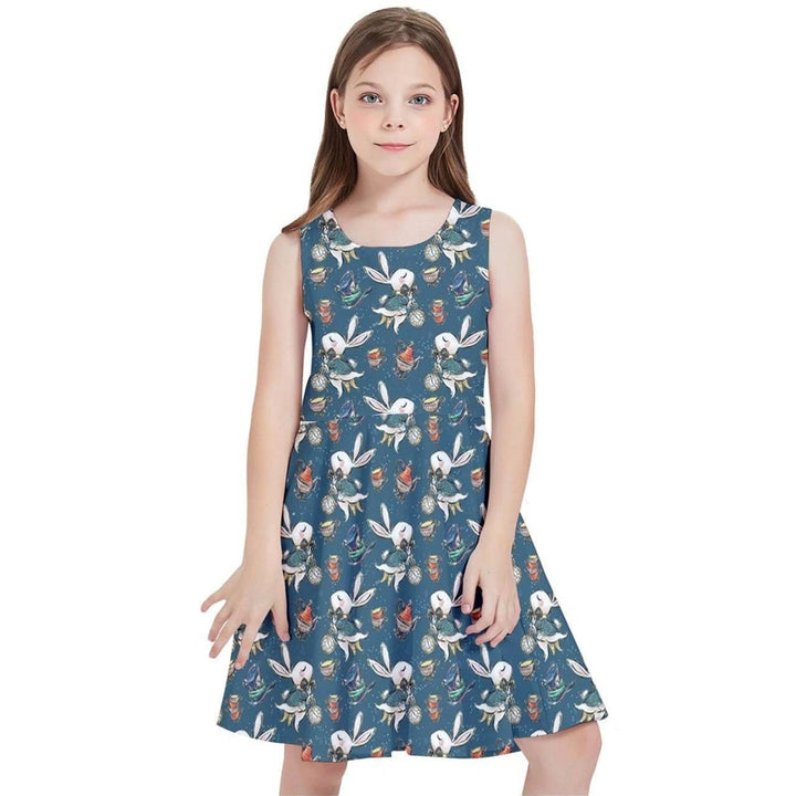 Young girl wearing Down the Rabbit Hole Kids' Skater Dress featuring whimsical Alice in Wonderland design on a vibrant blue background.