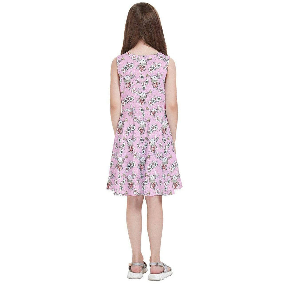 Back view of a girl's skater dress featuring a whimsical Alice in Wonderland print on a pink background.