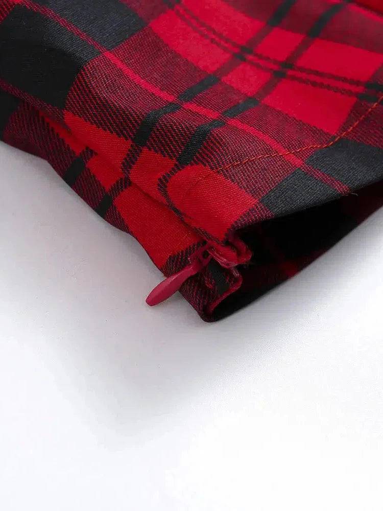 Close-up of the side zipper detail on a red plaid retro top, showcasing bold colors and stylish design.